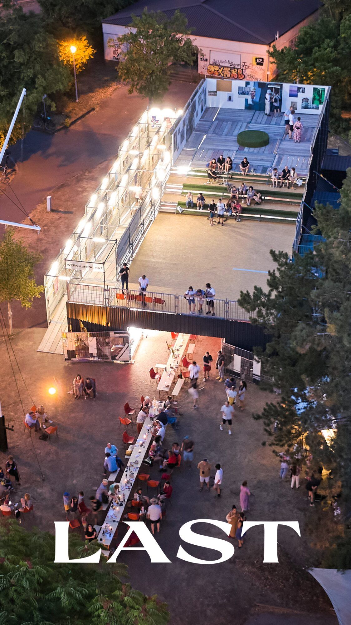 Hochformatiges Luftbild des beleuchteten Gerüsts mit Publikum davor, unten das Wort „Last“.